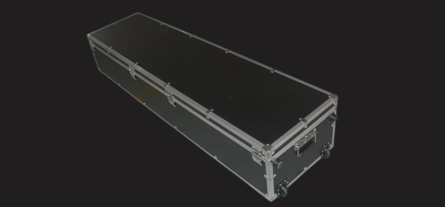 Long black flight case with metal edges and latches for equipment transport