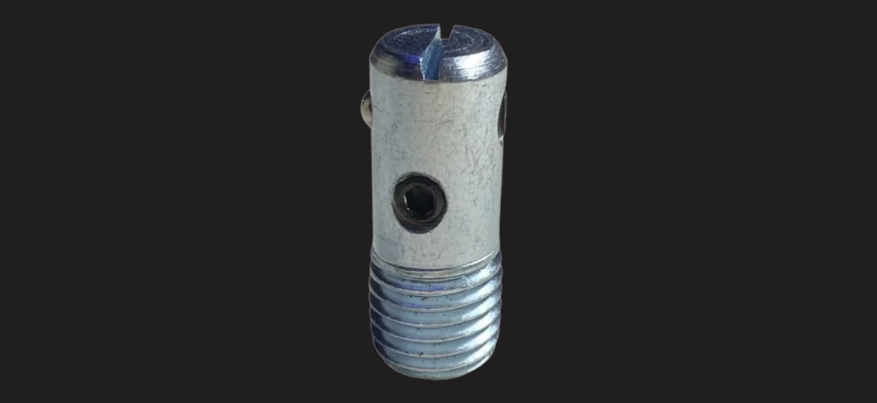 Metal cylindrical tool with external threads on the bottom, a side hole, and a split-slotted top against a dark background.